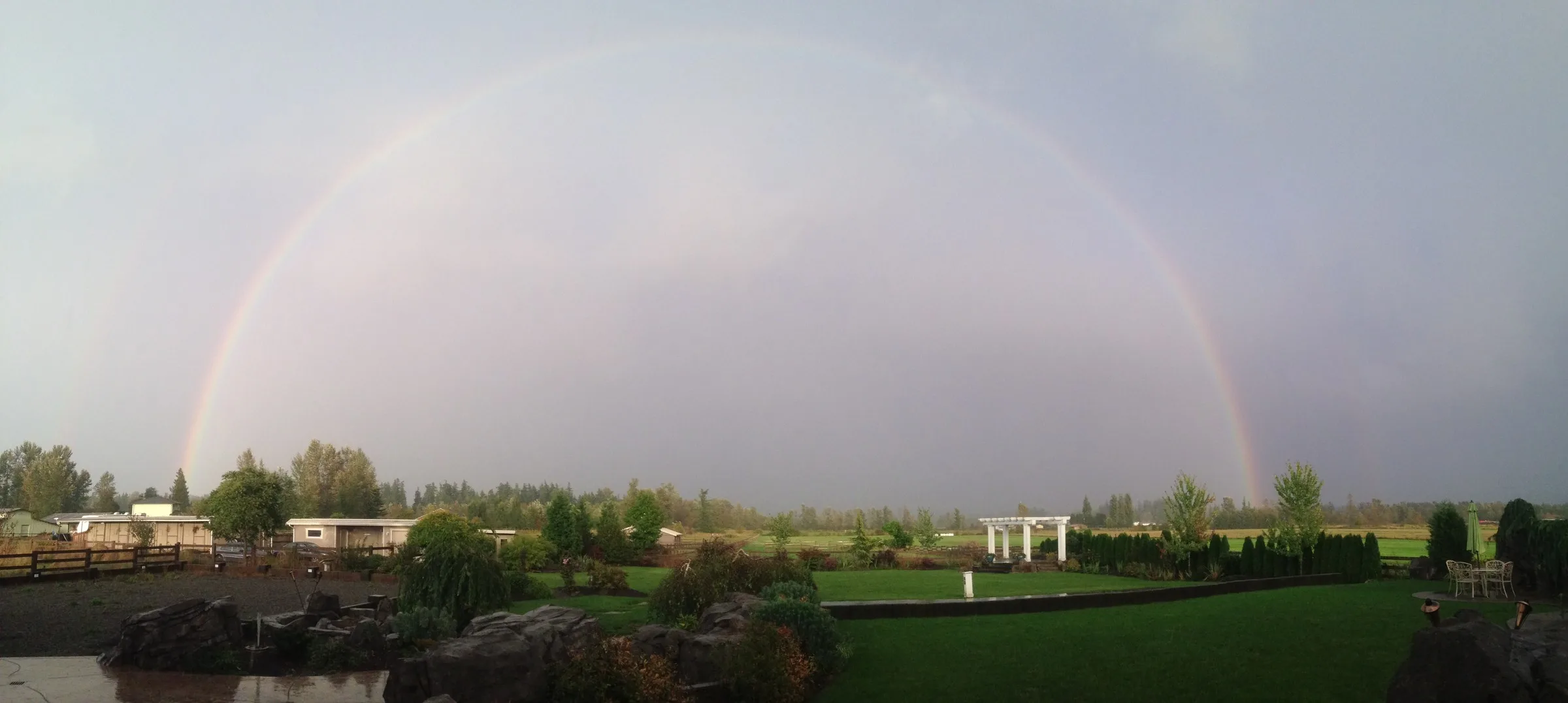 full double rainbow over mountain view manor enumclaw washington - Private Events A breathtaking full double rainbow arching over the lush green grounds and pergola of Mountain View Manor wedding venue in Enumclaw Washington near Seattle