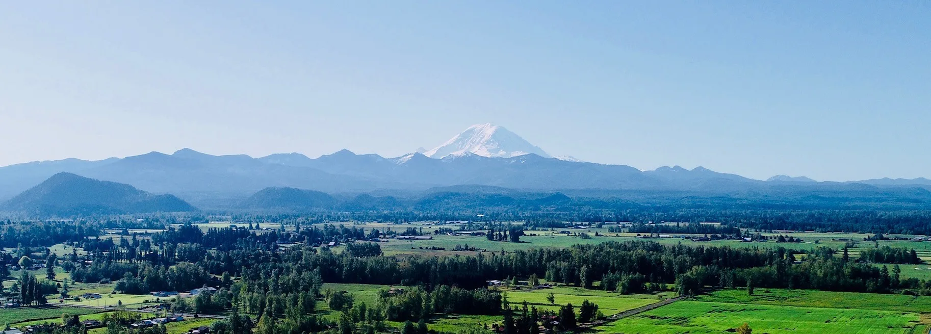 mountain view manor wedding venue enumclaw washington mount rainier - Mountain View Manor Panoramic view of Mount Rainier rising above green farmland and forests as seen from Mountain View Manor wedding venue in Enumclaw Washington near Seattle