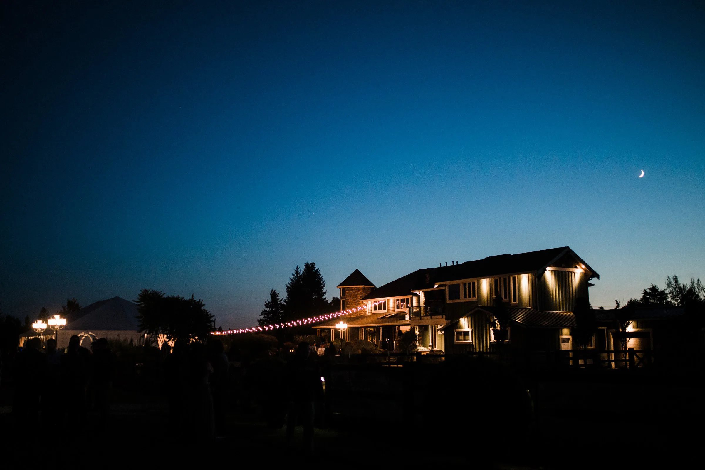 mountain view manor wedding venue night enumclaw washington - Mountain View Manor Mountain View Manor wedding venue illuminated at twilight with string lights and a crescent moon above, Enumclaw Washington near Seattle