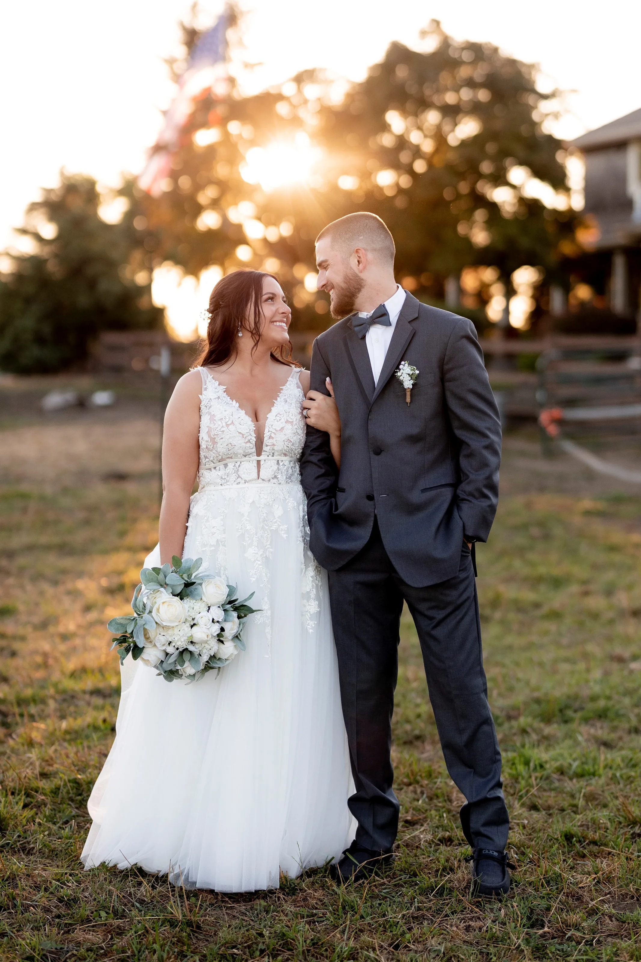 sunset bride groom portrait mountain view manor enumclaw - Packages & Pricing Bride and groom share a romantic sunset moment at Mountain View Manor wedding venue in Enumclaw Washington, with the bride holding a white rose and eucalyptus bouquet and the groom in a charcoal suit with bow tie